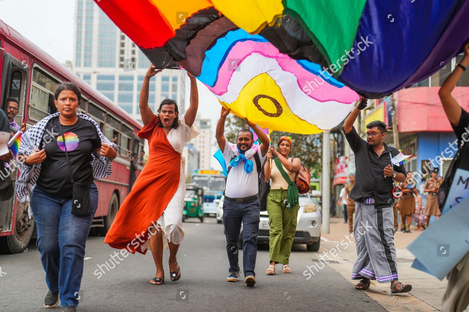 LGBTQ+ travelers participating in traditional Sri Lankan ceremony with local community members - cultural bridge
