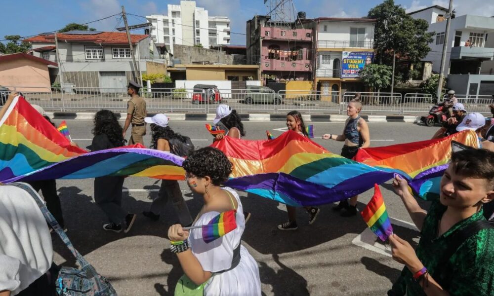 LGBTQ+ travelers and locals connecting on beautiful Sri Lankan beach at sunset - community-led tourism initiative